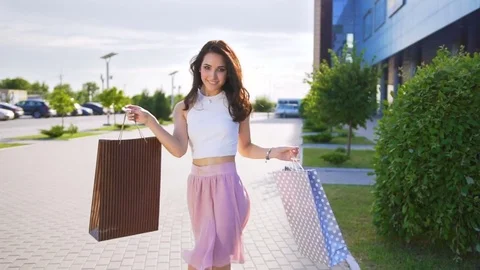 Young handsome woman is dancing after shopping Stock Footage