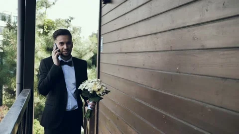 Young happy bearded groom talking on the phone Stock Footage 209156550