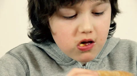 Young happy boy eating fast food, hamburger and french fries and drinking cola Stock Footage