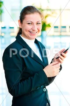 Young happy business woman with a mobile phone in hand Stock Photos