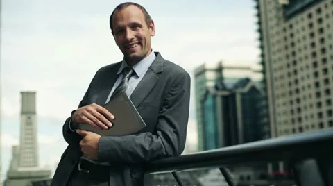 Young happy businessman with tablet computer in the city HD Video stock 11514302