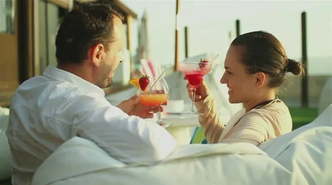 Young happy couple drinking exotic cocktails  HD Stock Footage 10901708