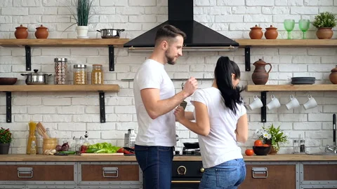 Young happy couple having fun, dance at the kitchen. Video stock 105102371