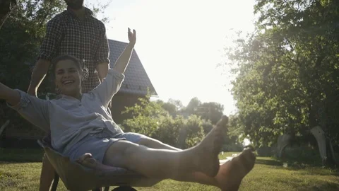 Young happy couple having fun and riding a country trolley. Stock Footage 111414835