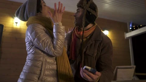 Young happy couple having fun using smartphone in chalet. Stock Footage 167650156