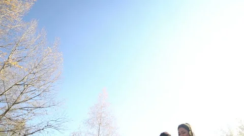 Young happy couple listening to music on headphones at the park Stock Footage 59554746