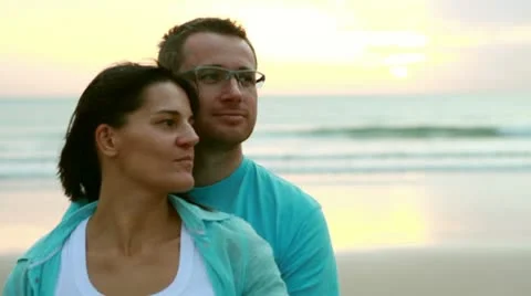 Young happy couple looking at something on the beach Stock-Footage 10760922