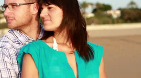 Young happy couple looking at something on the beach Stock Footage 10763886