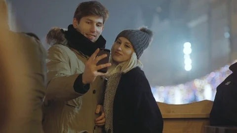 Young happy couple making winter selfie outdoor. Stockbeeldmateriaal 70878837