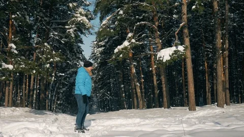 Young happy couple running through snowy forest at cold winter day. Stock Footage 86561035
