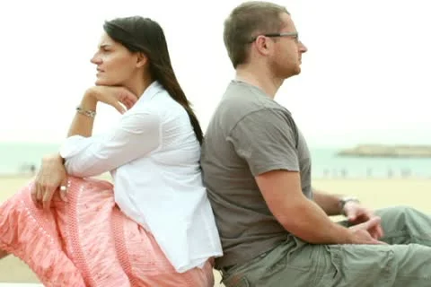 Young happy couple siting by the beach Видео 10791802