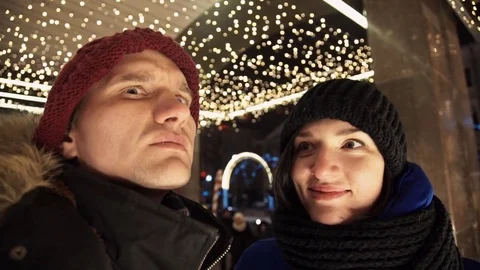 Young happy couple spends time together on busy urban street in evening Video stock 83918358