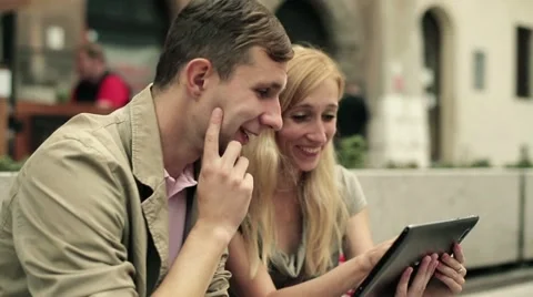 Young happy couple with tablet computer in the city, steadicam shot HD Stock Footage 11885885