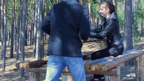 Young happy couple using smartphone in spring autumn forest park Stock Footage 75670934