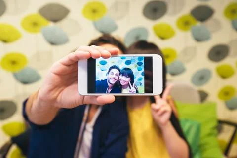 Young happy couple using smartphone in the bar Foto stock