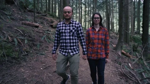 Young happy couple walking in forest Stock Footage 82443827