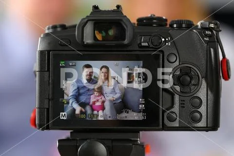 Young happy family sit on couch making photo session portrait Stock Photos