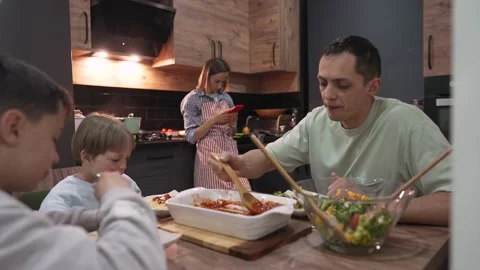 Young happy family talking while having dinner at home table 스톡 동영상 192228375