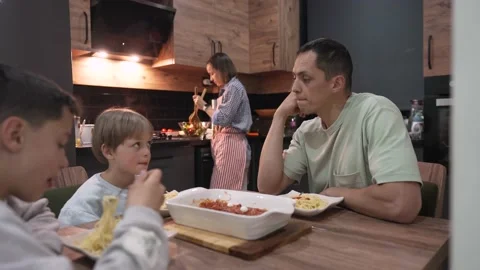 Young happy family talking while having dinner at home table 스톡 동영상 196980635