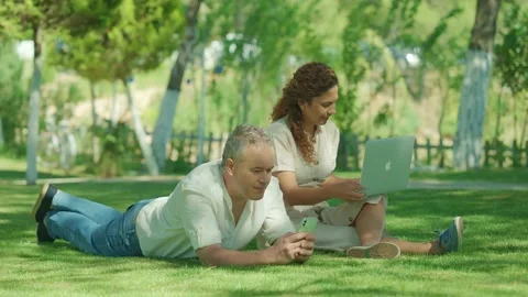 Young happy freelancer couple having picnic outdoors. Stock Footage 166226964
