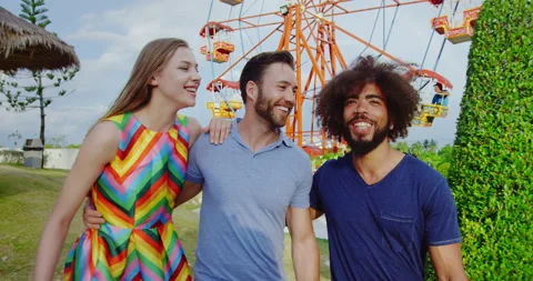 Young happy group of multi cultural friends walking together in amusement park i Video stock 201096232