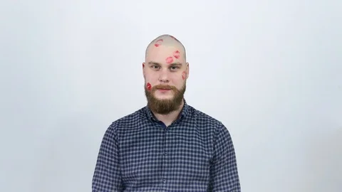 Young happy guy with a face covered with traces of kisses. Lipstick. Stock Footage 121975395
