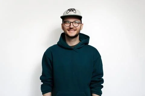 Young happy guy looking at camera while smiling, isolated on white studio b.. Stock Photos