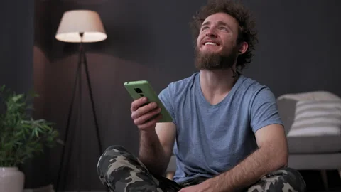 Young happy guy with smartphone, read news from phone. High-quality video post Stock Footage 159217899