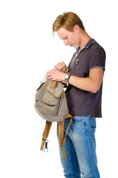 Young happy looking for something inside backpack Stock Photos