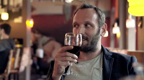 Young, happy man drinking wine and relaxing in cafe HD Stock Footage 55648037