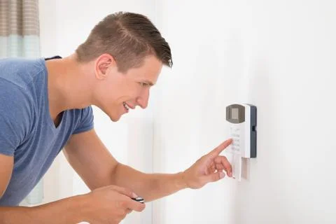Young Happy Man Entering Code In Door Security System Stock Photos