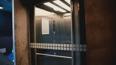Young happy man enters elevator, pushes the button, door closes and he rides up Video stock 94431091