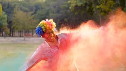 Young happy man having fun during joyful Holi celebration - Indian festival a... Stock Photos