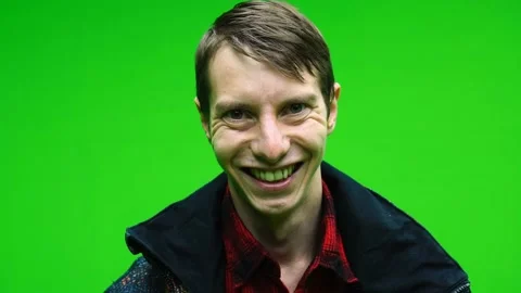 Young happy man looking at camera and smiling on green screen background Stock Footage 142695467