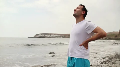 Young happy man standing on the beach HD Stock Footage 10851165