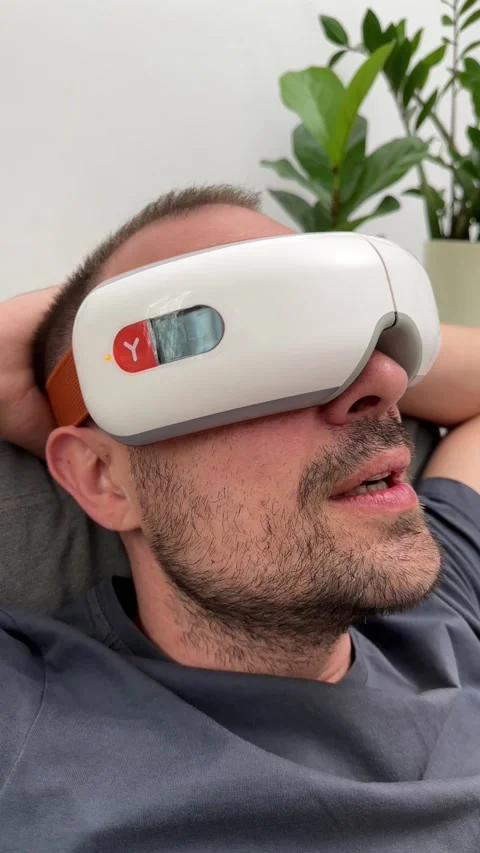 Young happy man using facial and eye massager. Stock Footage 239910879