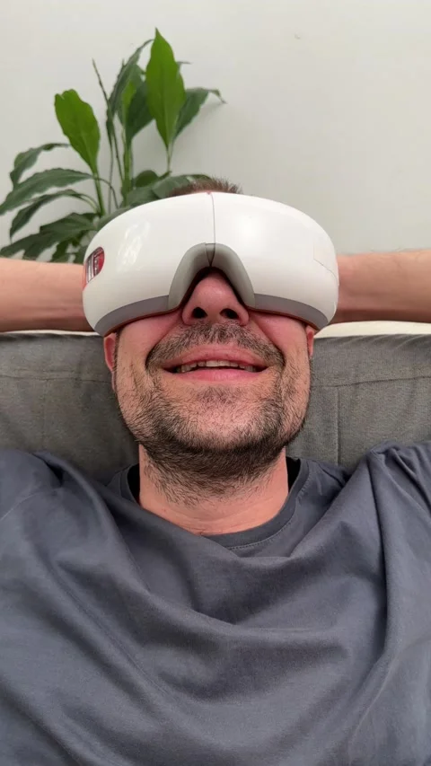 Young happy man using facial and eye massager. Stock Footage 239912552