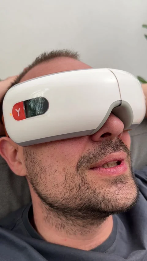 Young happy man using facial and eye massager. Stock Footage 240206873
