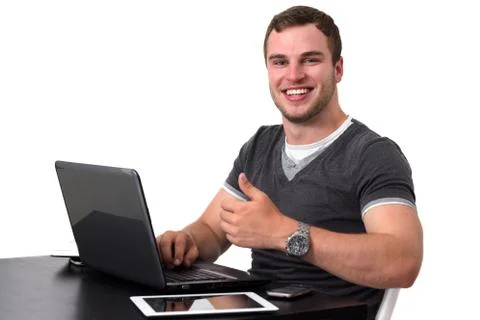 Young happy man working on pc Stock Photos