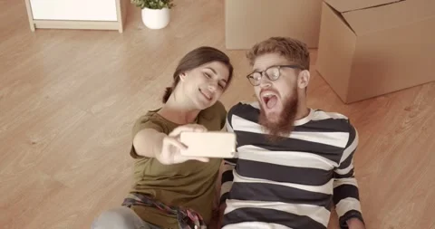 Young happy married couple lying on floor in new apartment. Husband and wife Stock Footage 144631192