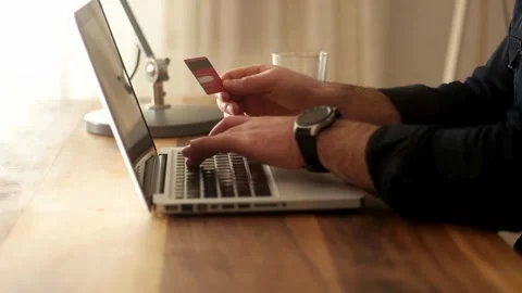 Young happy middle eastern guy making payment on laptop credit score and Stock Footage 265928883