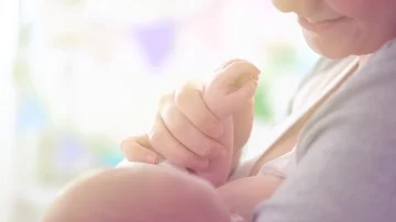 Young happy mother feeding her newborn baby. Breastfeeding concept Stock Footage