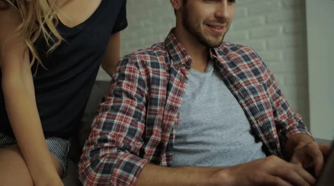 Young happy people using laptop at home Stock Footage 68801587