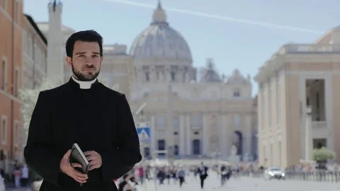  young happy priest smiling at the camera- Saint Peters Baslica 스톡 동영상 76438543