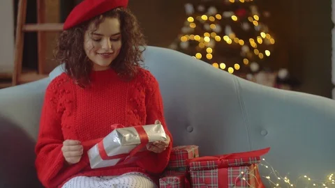 Young happy smiling lady checking, shaking, sorting Cristmas gift boxes, posing Stock Footage 100050897