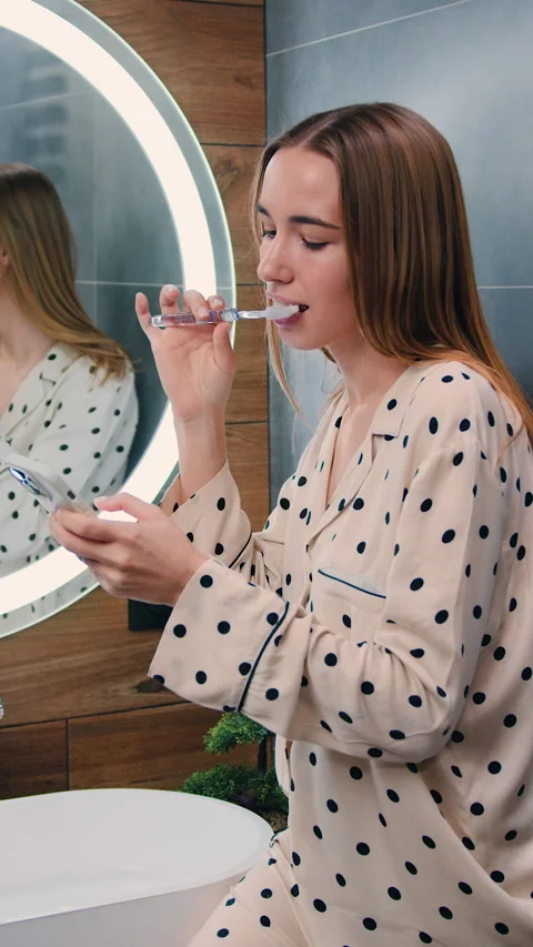 Young happy smiling woman is using smartphone for work or entertainment while br Stock Footage 325335834