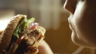 Young Happy Woman Eating Tasty Fast Food Burger, Close-Up Stock Footage