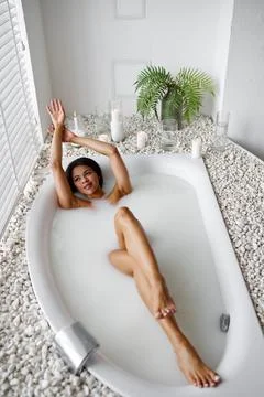 Young happy woman, relaxation in bath with milk Stock Photos