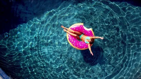 Teenage Girl Floating in Tube in Pool Stock Photo - Image of sunny