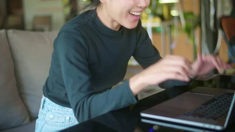A young happy woman is surprising while using computer laptop in cafe. people Vídeos de archivo 146124148